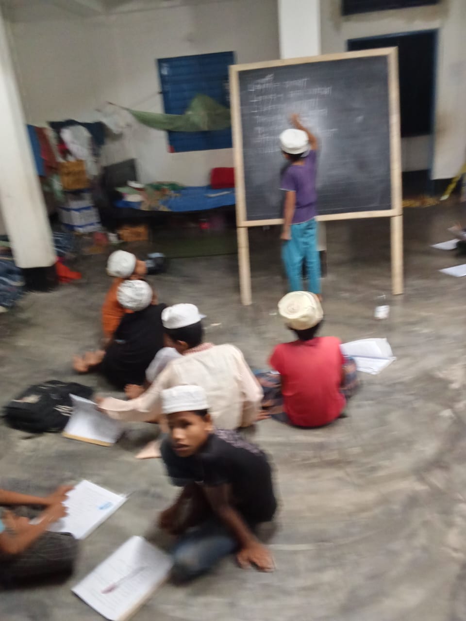 Students studying as one writes on the blackboard