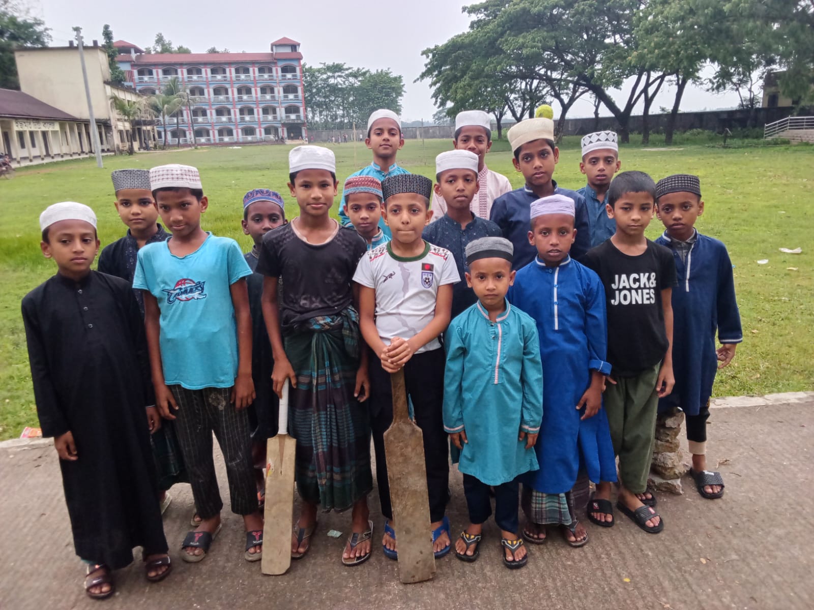 Students enjoying cricket on the sports field
