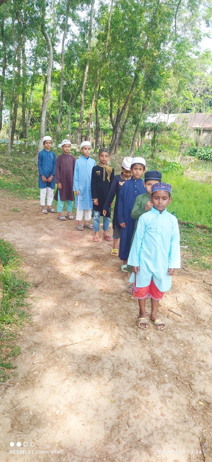 Students lined up outdoors in the greenery
